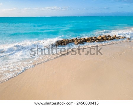 rocks on empty white sand shore of grace bay beach, Turks and Caicos Islands  Royalty-Free Stock Photo #2450830415