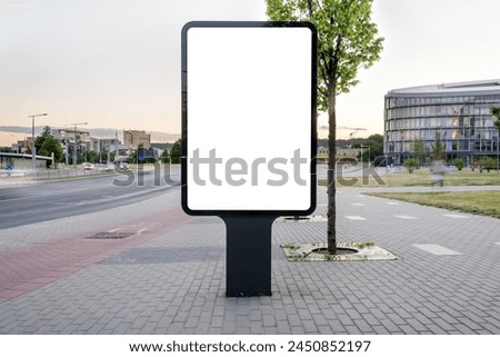 Blank Outdoor Poster Billboard Mockup On The Empty City Street. Vertical Advertising Lightbox In Front Of Urban Background