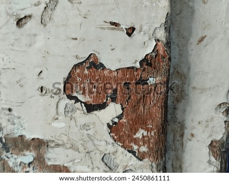 close up of white wood paint peeling because it has been around for a long time