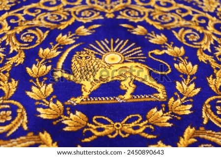 PURE SILK CARPET from Qom, Iran, motif lion and sun, The Lion and Sun is one of the main emblems of Iran and formerly was an element in Iran's national flag,   Close-up of the Rug's center  Royalty-Free Stock Photo #2450890643