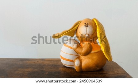 A cute bunny holding an easter egg. authentic easter bunny stock photos