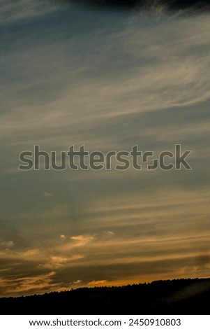 Cloudscape, Colored Clouds at Sunset near the River Elbe. vertical photo