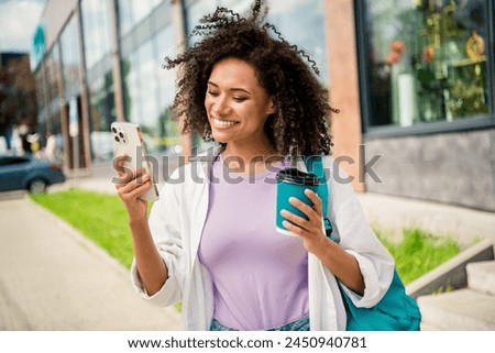 Photo of shiny pretty lady wear white shirt backpack drinking tea recording video modern device outside urban city street