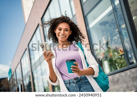 Photo of pretty adorable lady wear white shirt backpack drinking tea chatting modern device outside urban city street