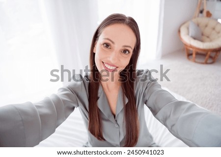 Photo of cute charming lady wear grey pajama enjoy weekend tacking selfie indoors house bedroom