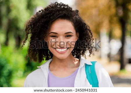 Photo of shiny good mood lady wear white shirt rucksack enjoying sunny weather travelling outside urban city park