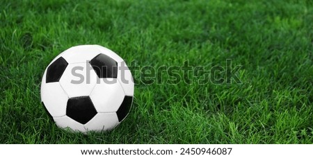 Soccer ball on green grass outdoors. Banner for design