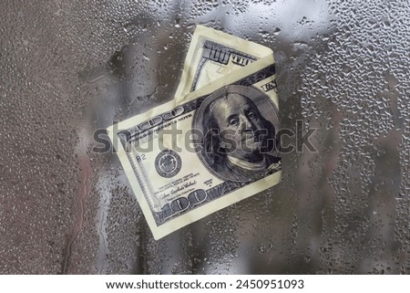 dollar bill concept. on wet glass