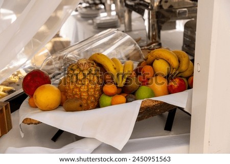 Assortiment of fruits with banana, pineapple, kiwi in a breakfast buffet.  Royalty-Free Stock Photo #2450951563
