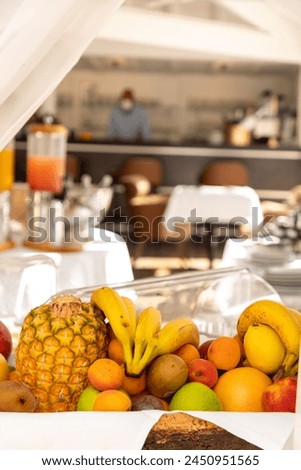 Assortiment of fruits with banana, pineapple, kiwi in a breakfast buffet.  Royalty-Free Stock Photo #2450951565