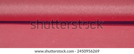 The silk fabric is ruby red. texture of colored silk fabric - can be used as a background