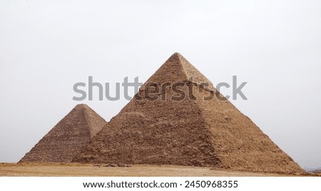 The Great Pyramid and Pyramid of Khefre at the Giza Pyramid Complex in Giza, Egypt, also called the Giza Necropolis. It was built during the Fourth Dynasty of the Old Kingdom Royalty-Free Stock Photo #2450968355