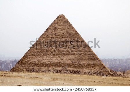 The pyramid of Menkaure at the Giza Pyramid Complex in Giza, Egypt, also called the Giza Necropolis. It was built during the Fourth Dynasty of the Old Kingdom Royalty-Free Stock Photo #2450968357