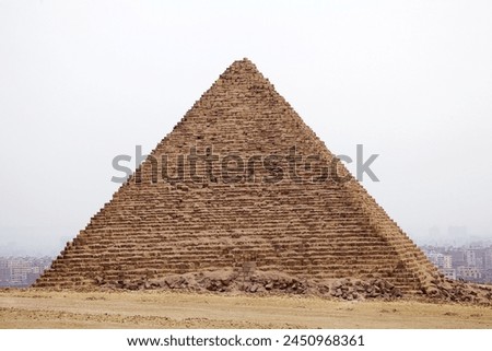 The pyramid of Menkaure at the Giza Pyramid Complex in Giza, Egypt, also called the Giza Necropolis. It was built during the Fourth Dynasty of the Old Kingdom Royalty-Free Stock Photo #2450968361