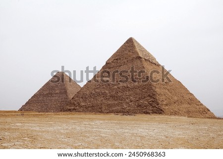 The Great Pyramid and Pyramid of Khefre at the Giza Pyramid Complex in Giza, Egypt, also called the Giza Necropolis. It was built during the Fourth Dynasty of the Old Kingdom Royalty-Free Stock Photo #2450968363