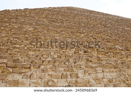 The side of the Great Pyramid at the Giza Pyramid Complex in Giza, Egypt, also called the Giza Necropolis. It was built during the Fourth Dynasty of the Old Kingdom Royalty-Free Stock Photo #2450968369