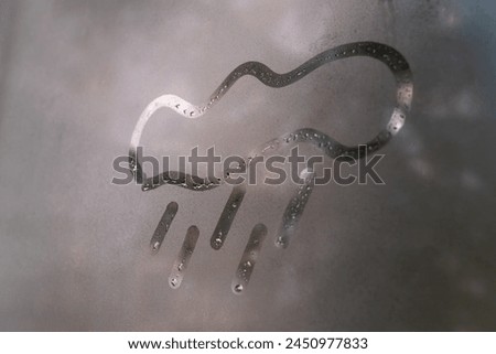 Painted cloud with rain on the fogged glass, copy the space. Concept of rainy weather, bad mood. Sign of bad weather