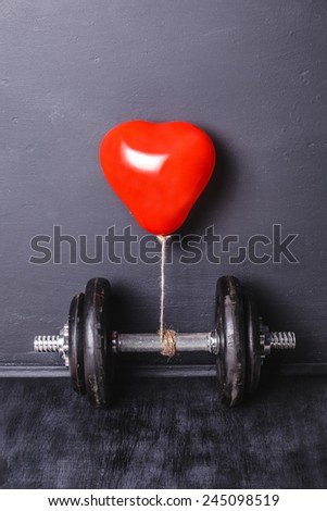 dumbbell with a red heart 