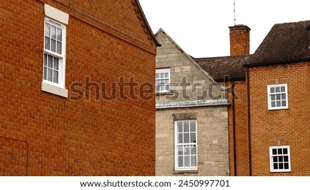 sash window facades of British houses against the sky Royalty-Free Stock Photo #2450997701