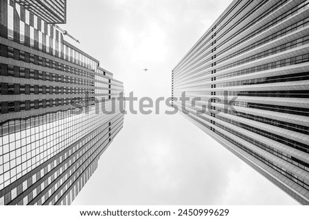 Black and white photograph of a tall city skyscraper.
