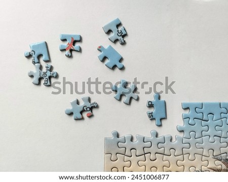 Scattered, incomplete puzzle on white background , work on progress Royalty-Free Stock Photo #2451006877