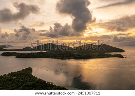 Dramatic view of rain clouds over ocean. Black and yellow clouds with rain. Island of Fiji.