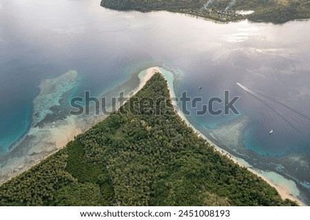 Fiji Islands. Turquoise waters of ocean wash island covered tropical vegetation. Travel concept