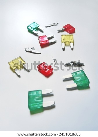 safety fuses for electronic equipment in vehicles. The more modern the era, the smaller the size with a capacity to withstand current that is comparable to older models. Royalty-Free Stock Photo #2451018685
