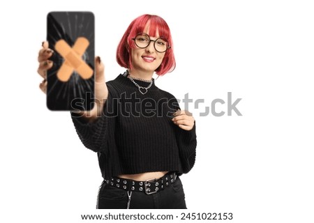 Young female holding a smartphone with a broken screen fixed with adhesive tape isolated on white background
