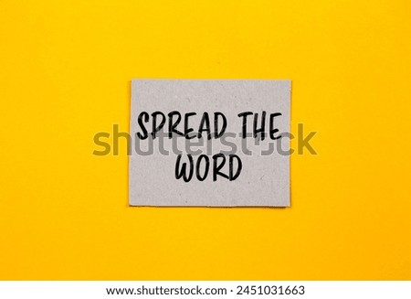 Spread the word written on paper piece with yellow background. Conceptual spread the word symbol. Copy space.
