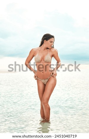 Woman, body and bikini on tropical island with confidence on holiday, summer vacation and relax on beach. Person, swimsuit or tourist at seaside for sun tan, fresh air and fun in nature on weekend
