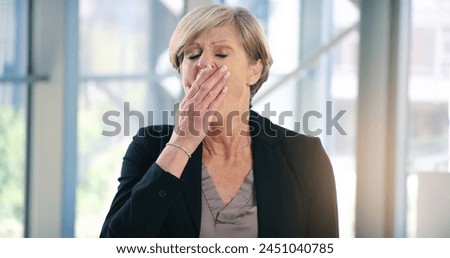 Mature, businesswoman and tired or corporate burnout as financial executive, overworked or deadline. Female person, hand and sleepy yawn in office building with insomnia problem, fatigue or exhausted