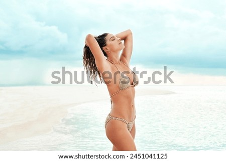Woman, confidence and bikini in water or tropical island for holiday, summer vacation and relax with blue sky. Person, swimsuit or tourist at seaside for sun tan, clean air and fun in Maldives beach