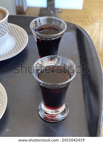 2 Turkish coffee served in a luxury porcelain cup, glass glass shot fruit liqueur next to it, chocolate cake next to it, wonderful service presentation Macro Detail shot different perspective angles.