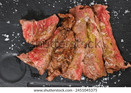 Skirts steak top view. Close up photo with a delicious beef diaphragm steak medium rare cooked on barbecue grill. Beef source of protein.
