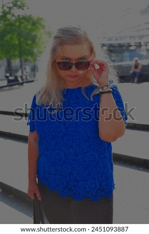 Woman visiting Rotterdam curvy blonde woman waking in the city cityscape skyline of the big city tourist holiday in Netherlands daytrip citytourist