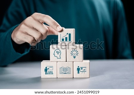 Training webinar E-learning concept. Businessman stacking wooden block with training icon. Educational technology and personal development.