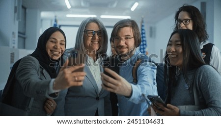 Happy diverse people take pictures with female presidential candidate after voting. Multiethnic US citizens with politician at polling station. National Election Day in the United States. Slow motion.