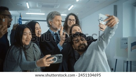 Happy diverse people take pictures with mature presidential candidate after voting. Multiethnic US citizens with politician at polling station. National Election Day in the United States. Slow motion.
