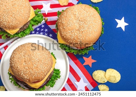 Homemade burgers. An American classic, traditional food for picnic, party or celebration Independence Day. Hard light, dark shadow, flat lay, blue background, top view