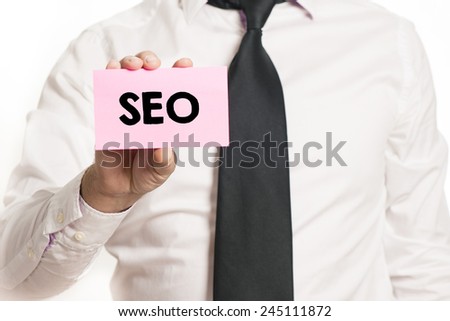 Businessman with SEO text. Businessman holding paper with SEO text isolated over white background