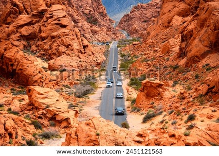 Narrow “White Domes Road“ scenic drive in the Valley of Fire State park near Las Vegas, Nevada (USA). Colorful sandstone rocks in the Mojave Desert, view points and trails are a popular touristi sight Royalty-Free Stock Photo #2451121563
