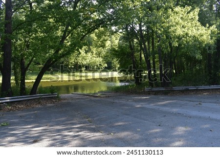 The boat ramp at Cross Timbers Access (Mo Dept of Conservation) near Hermitage, Hickory County, MO, Missouri, USA, United States allows boats to be launched on the Pomme de Terre River.  Royalty-Free Stock Photo #2451130113
