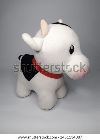 potrait of a cow doll on white background Royalty-Free Stock Photo #2451134387