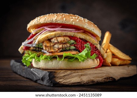 Vegetarian Burger with mushrooms, grilled vegetables, sauce and iceberg lettuce. Juicy delicious hamburger on darkmood picture for restaurant decoration, poster. 