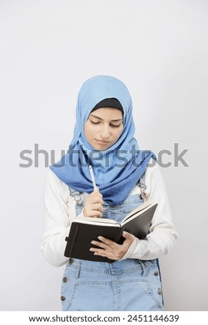 Time Management At Work. Smiling Islamic Female Employee Writing Notes, Managing Her Business 