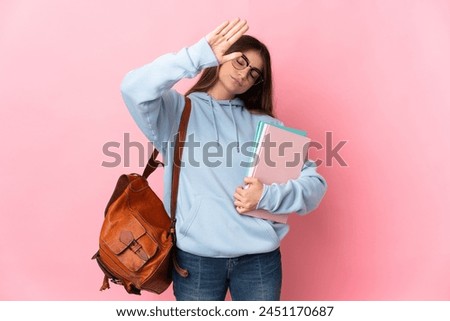 Young student woman isolated on pink background making stop gesture and disappointed