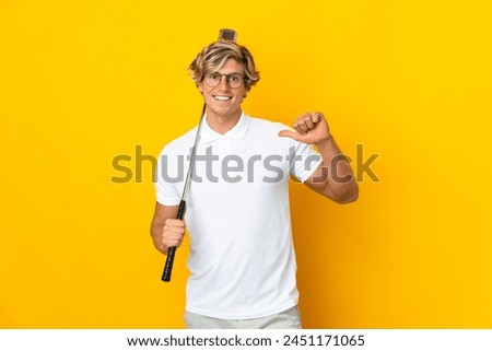 English man over isolated white background playing golf and proud of himself