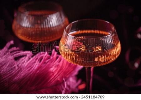 Extravagant glamour background with glass of sparkling wine for love party at muffled light. Beautiful romantic burlesque place for valentines holiday Royalty-Free Stock Photo #2451184709