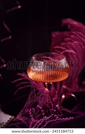 Extravagant glamour background with glass of sparkling wine for love party at muffled light. Beautiful romantic burlesque place for valentines holiday Royalty-Free Stock Photo #2451184713